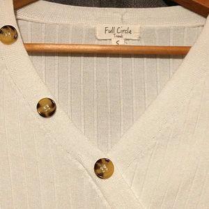 Bright cream colored, ribbed knit sweater dress.